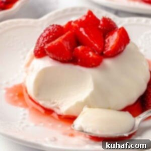 buttermilk panna cotta with strawberries bite on spoon.