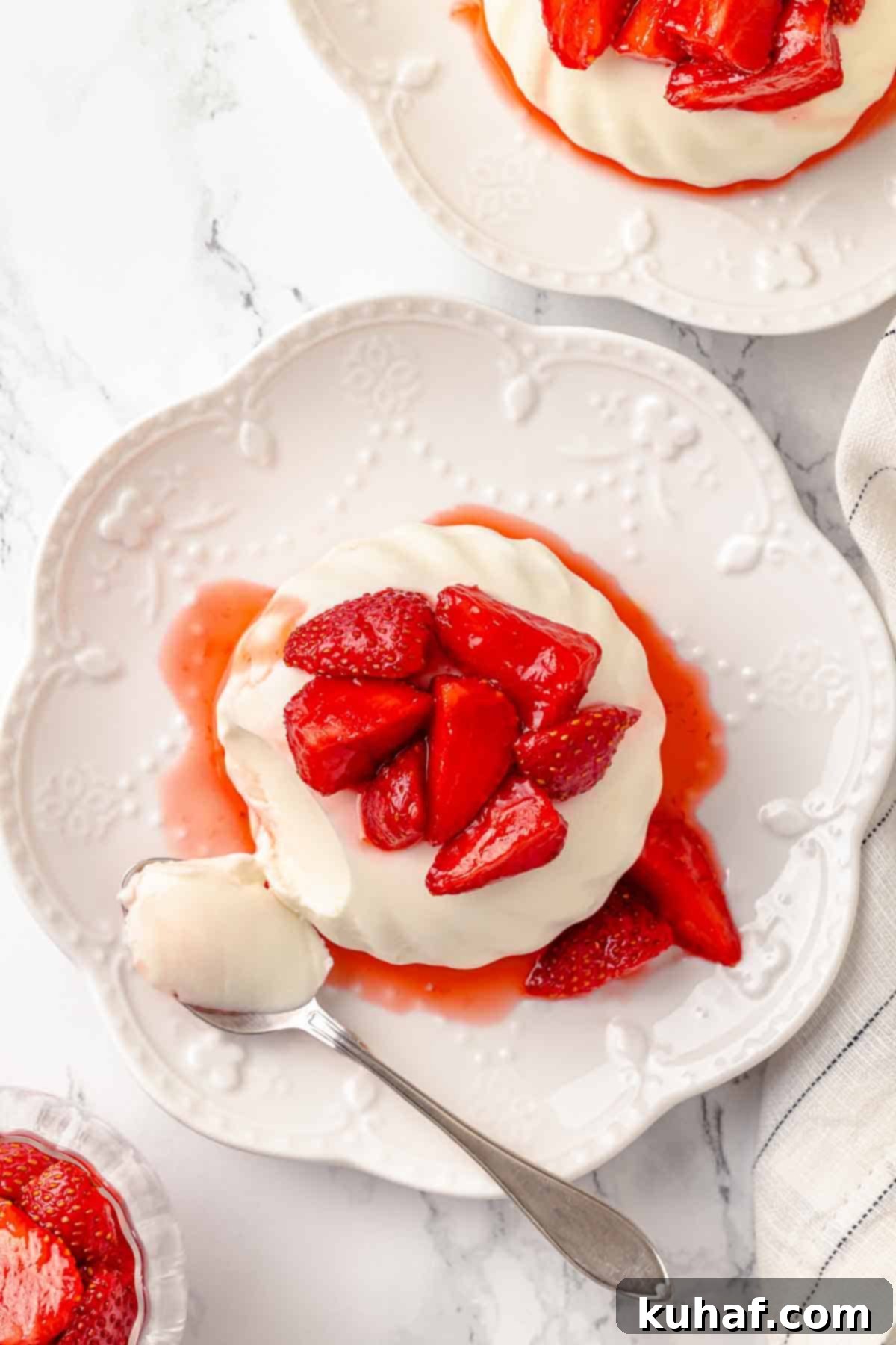 buttermilk panna cotta with macerated strawberries overhead.