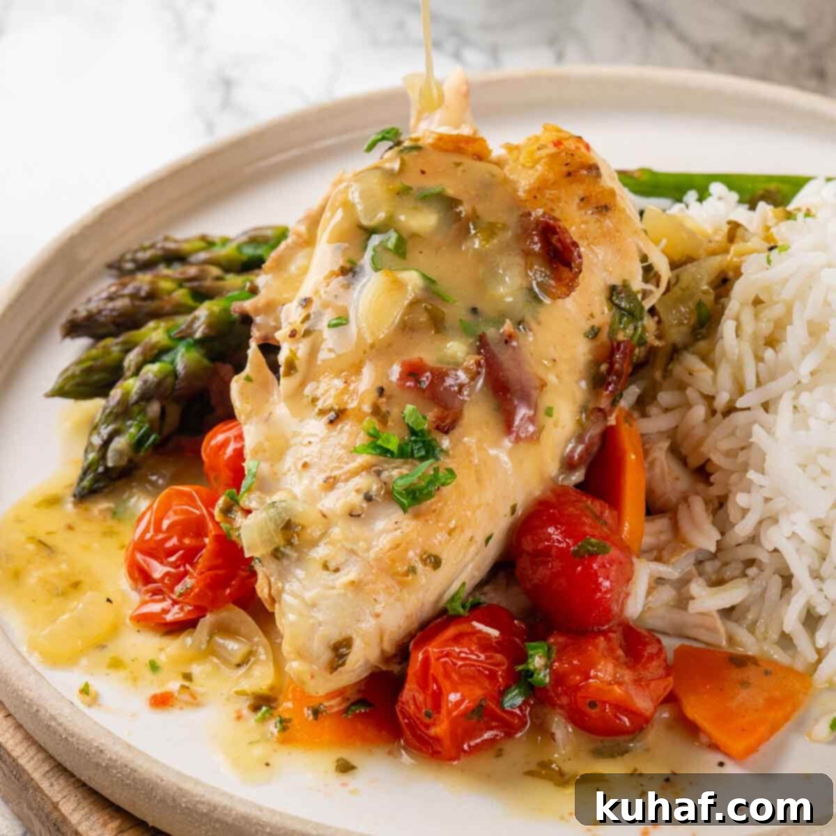 Cooked chicken in wine sauce garnished with fresh herbs, presented on a white marble countertop.