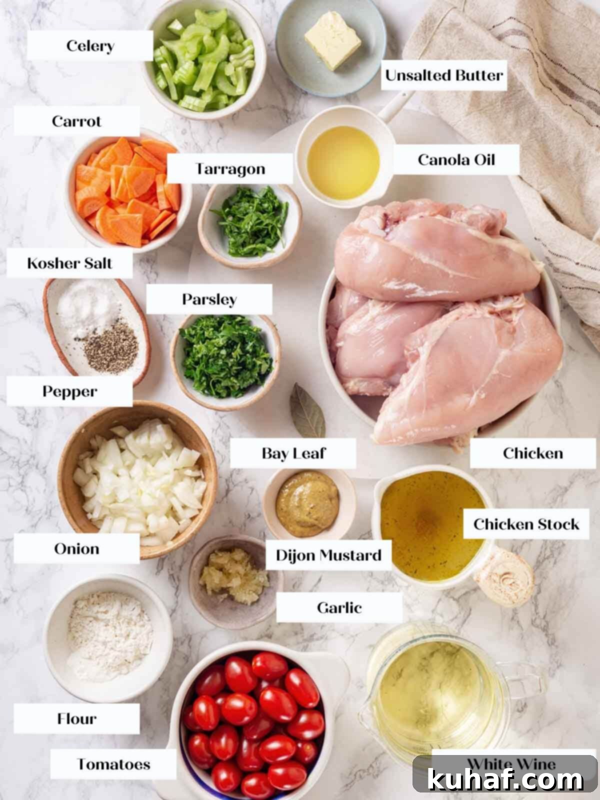 A selection of fresh ingredients for chicken in wine sauce, including chicken, vegetables, wine, and herbs, arranged on a white marble countertop.
