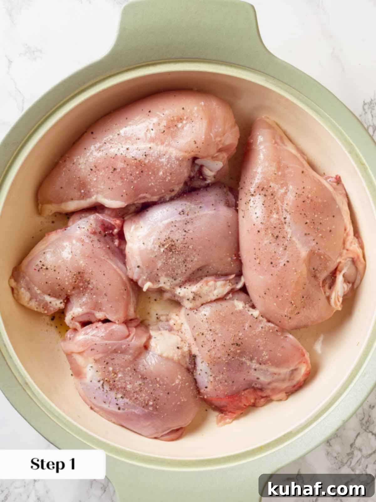 Raw chicken pieces seasoned with salt and pepper, ready for searing in wine sauce recipe.