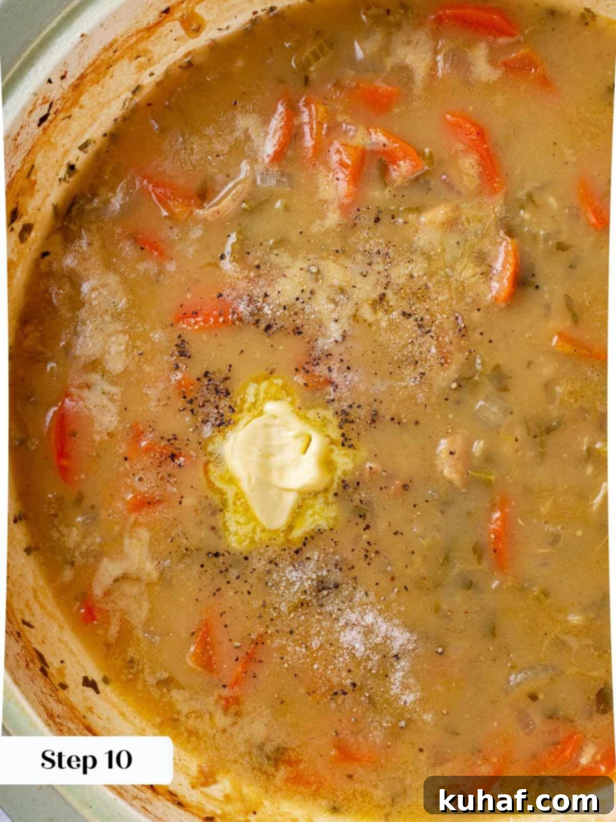 Chicken in wine sauce with butter being whisked into the reducing sauce in a skillet.