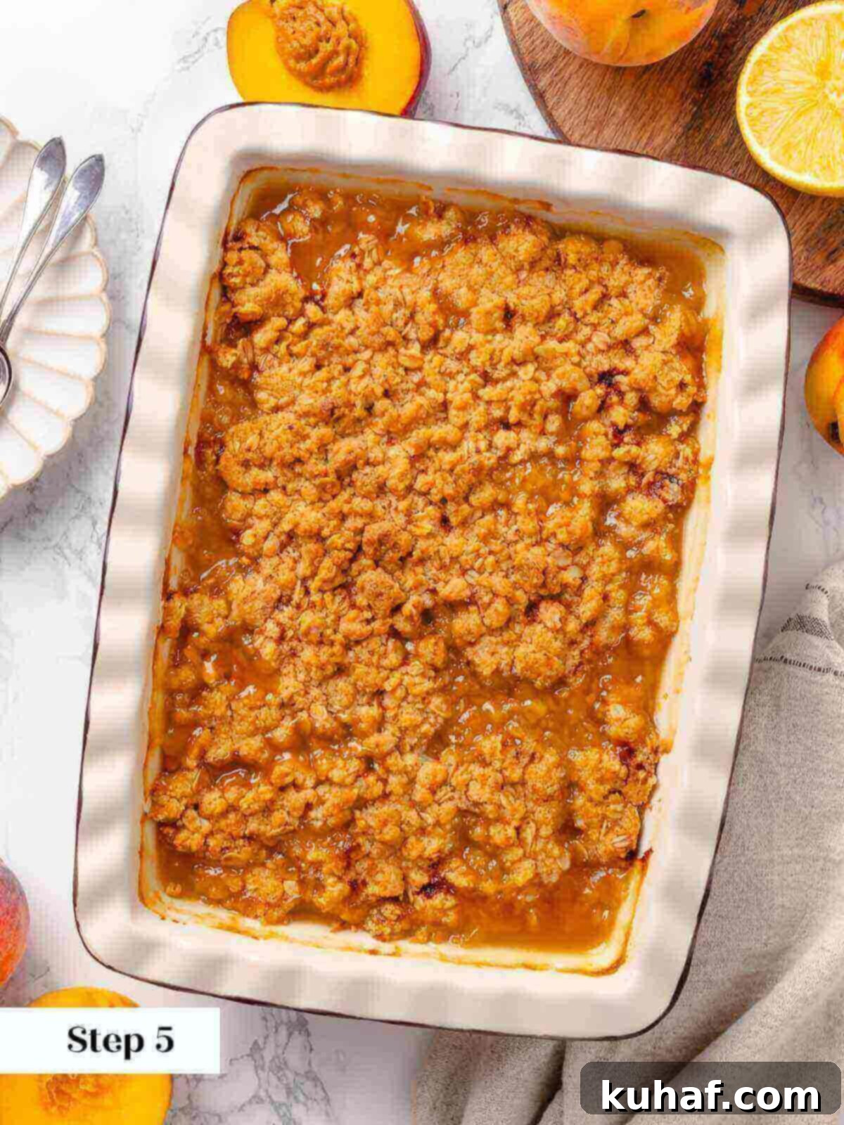 Baked peach crisp fresh out of the oven, with a golden-brown top.