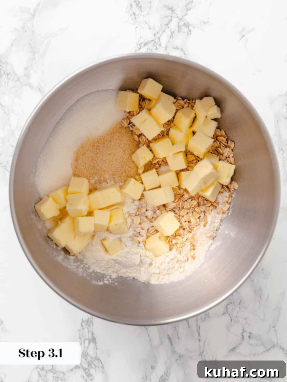 Cubed butter being mixed into the topping for peach crisp.