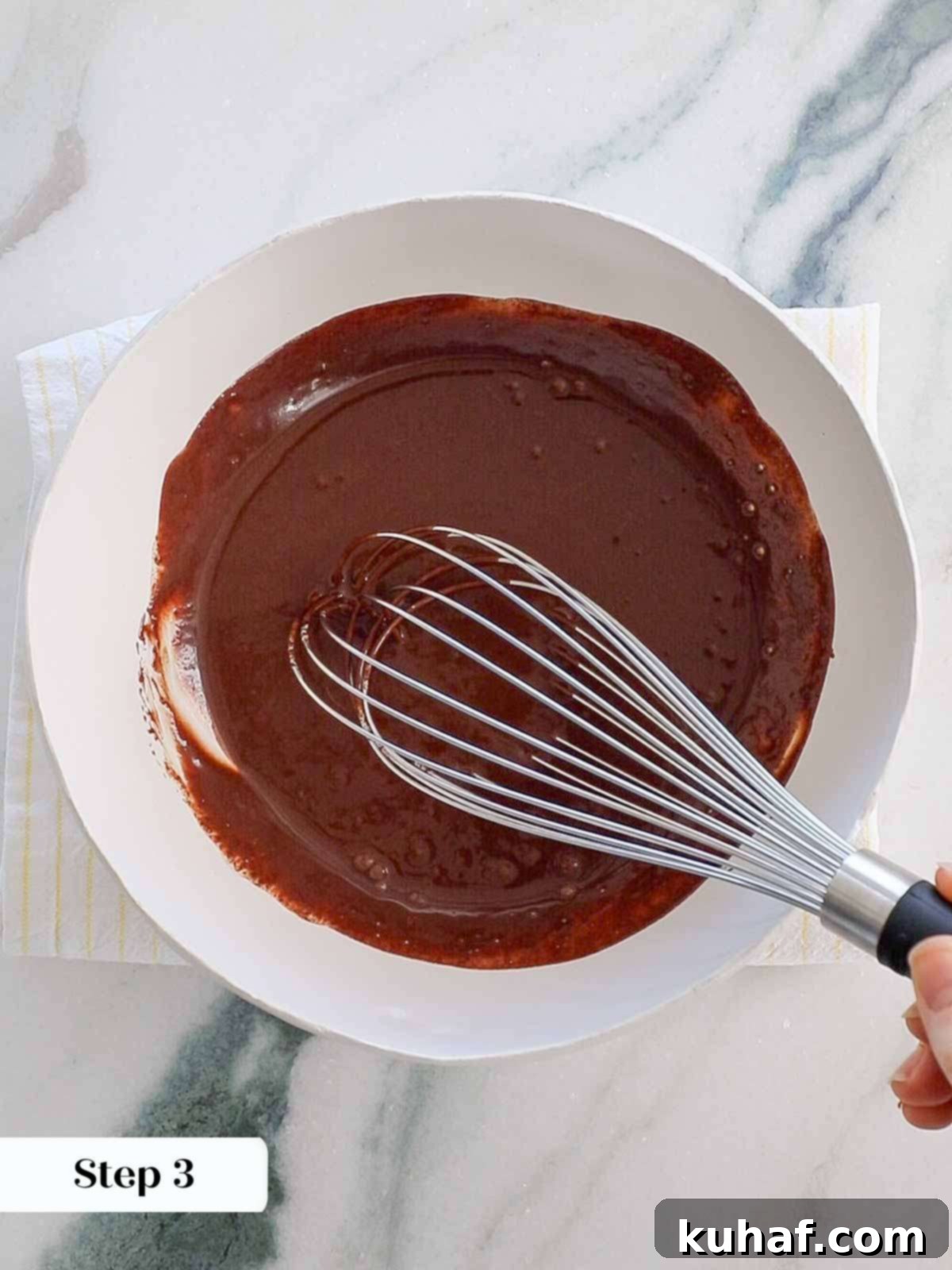 whisking ganache to emulsify.