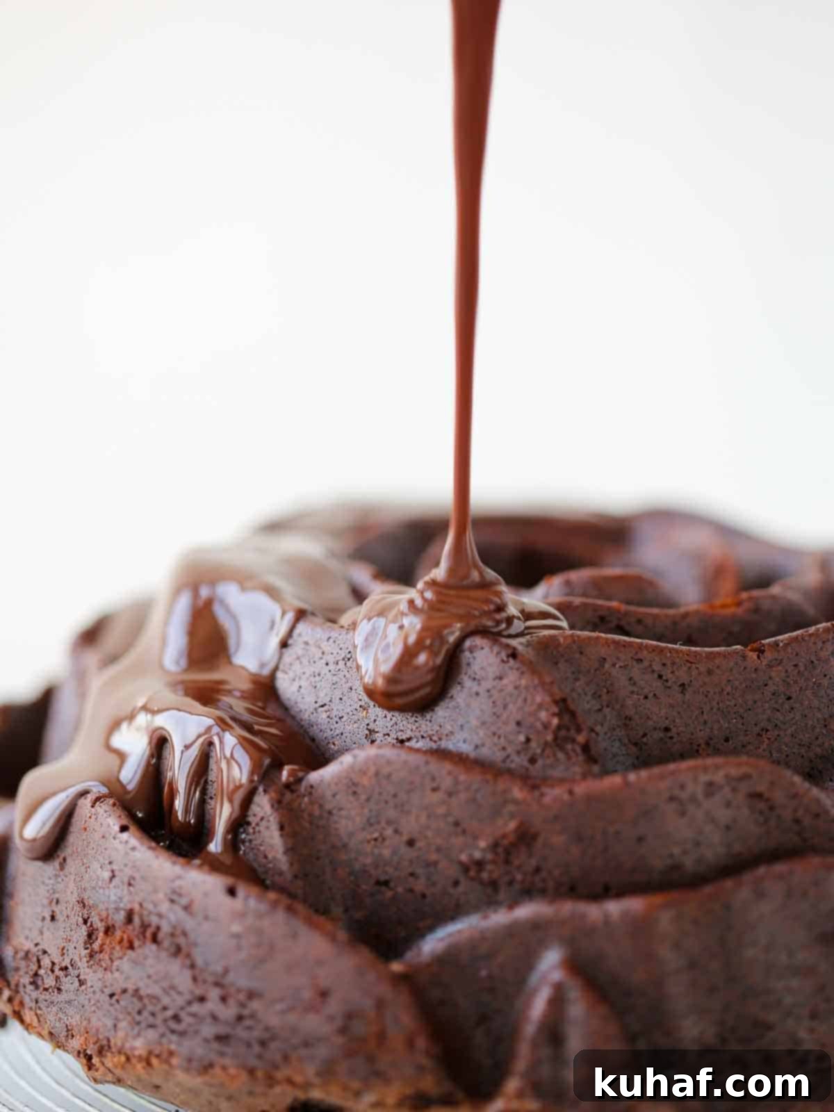 chocolate ganache pouring onto chocolate cake.