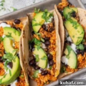 Flavorful chicken taco with creamy avocado and fresh chopped cilantro, a perfect blend of taste and texture.