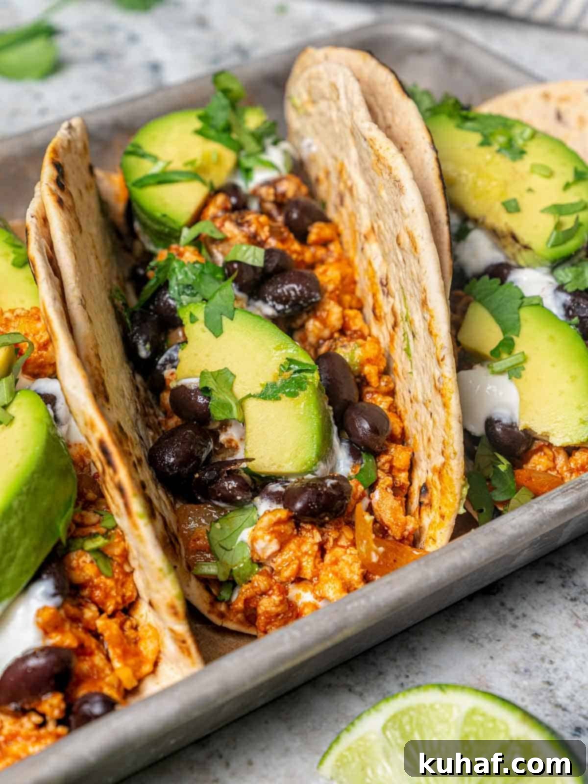 Close-up of a chipotle flavored ground chicken taco, showing the rich filling and fresh toppings.