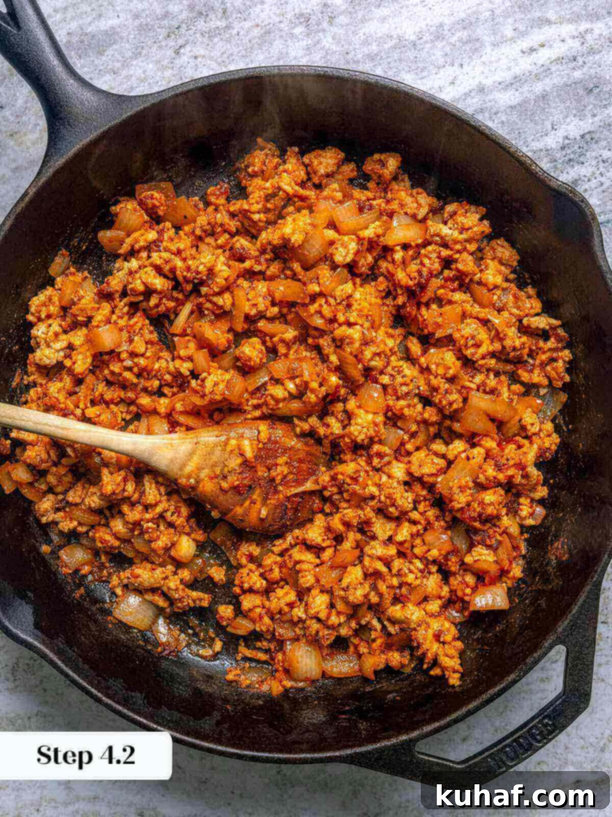 Close-up of the perfectly cooked and seasoned ground chicken taco meat in the skillet, ready for assembly.