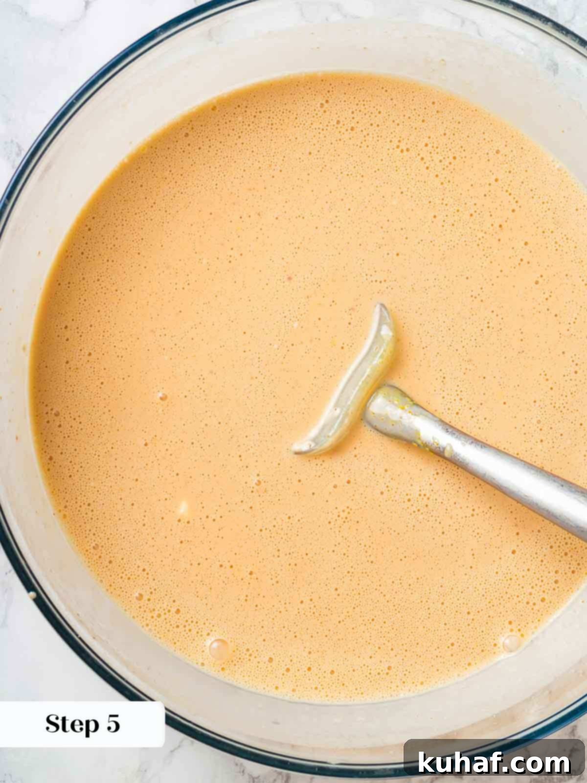 The fully prepared peach ice cream base, smooth and ready for chilling and churning.