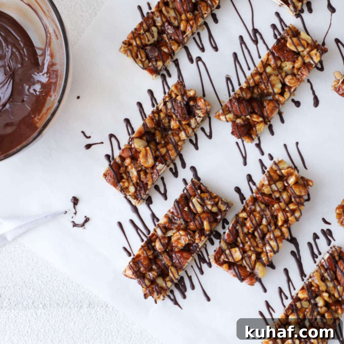 Melted dark chocolate in a cornet, ready for precise drizzling over freshly made Homemade KIND Bars.