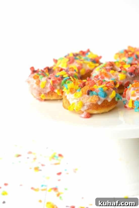 Fruity Pebble Cereal Milk Baked Donuts | soft, vanilla cake donuts made with Fruity Pebble cereal milk for a unique twist on breakfast!