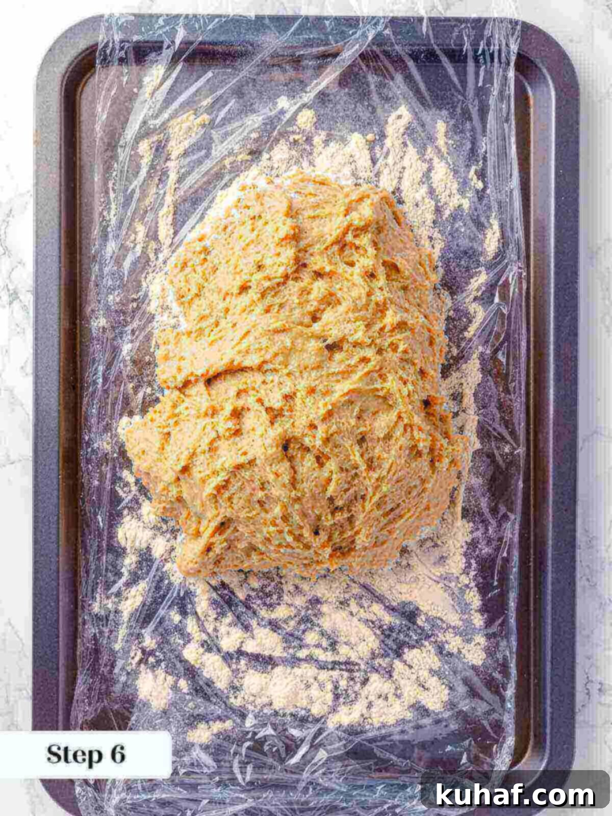 Apple cider donut dough resting in preparation for rolling.