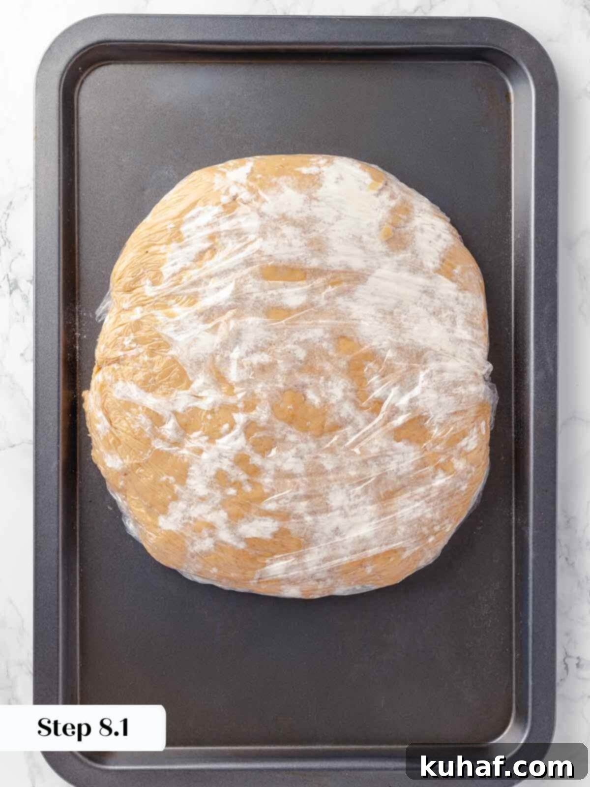 Apple cider donut dough resting on a sheet pan.
