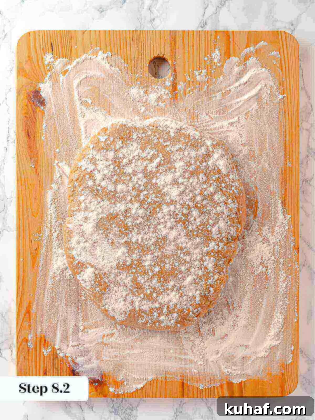Donut dough on a cutting board as part of the apple cider donuts process.