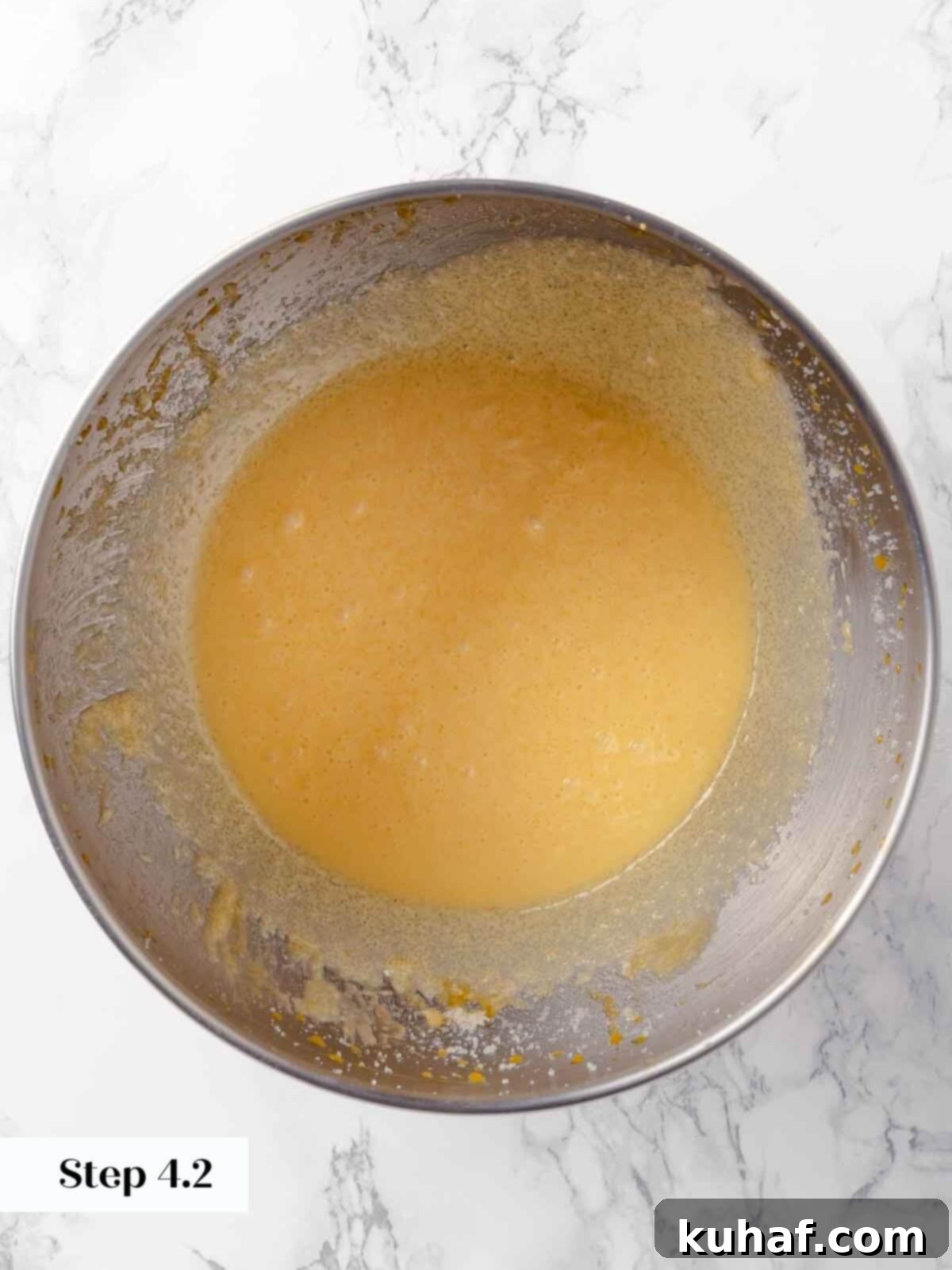 Adding egg yolks to the apple cider donut batter.