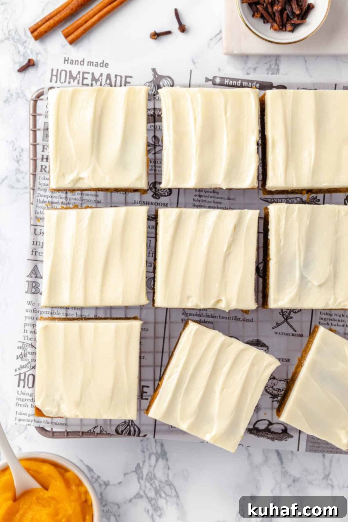 Delicious Autumn Pumpkin Squares 17 Pumpkin bars arranged on a white marble counter.