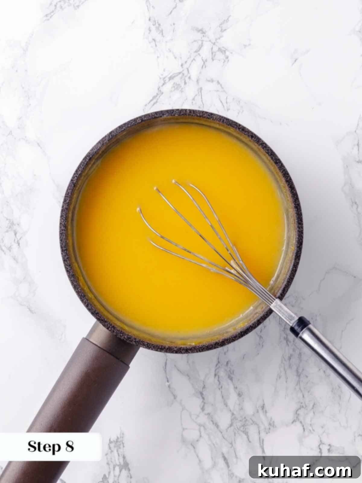 The lemon filling being continuously stirred over medium heat to ensure an even consistency and prevent any sticking or scorching.