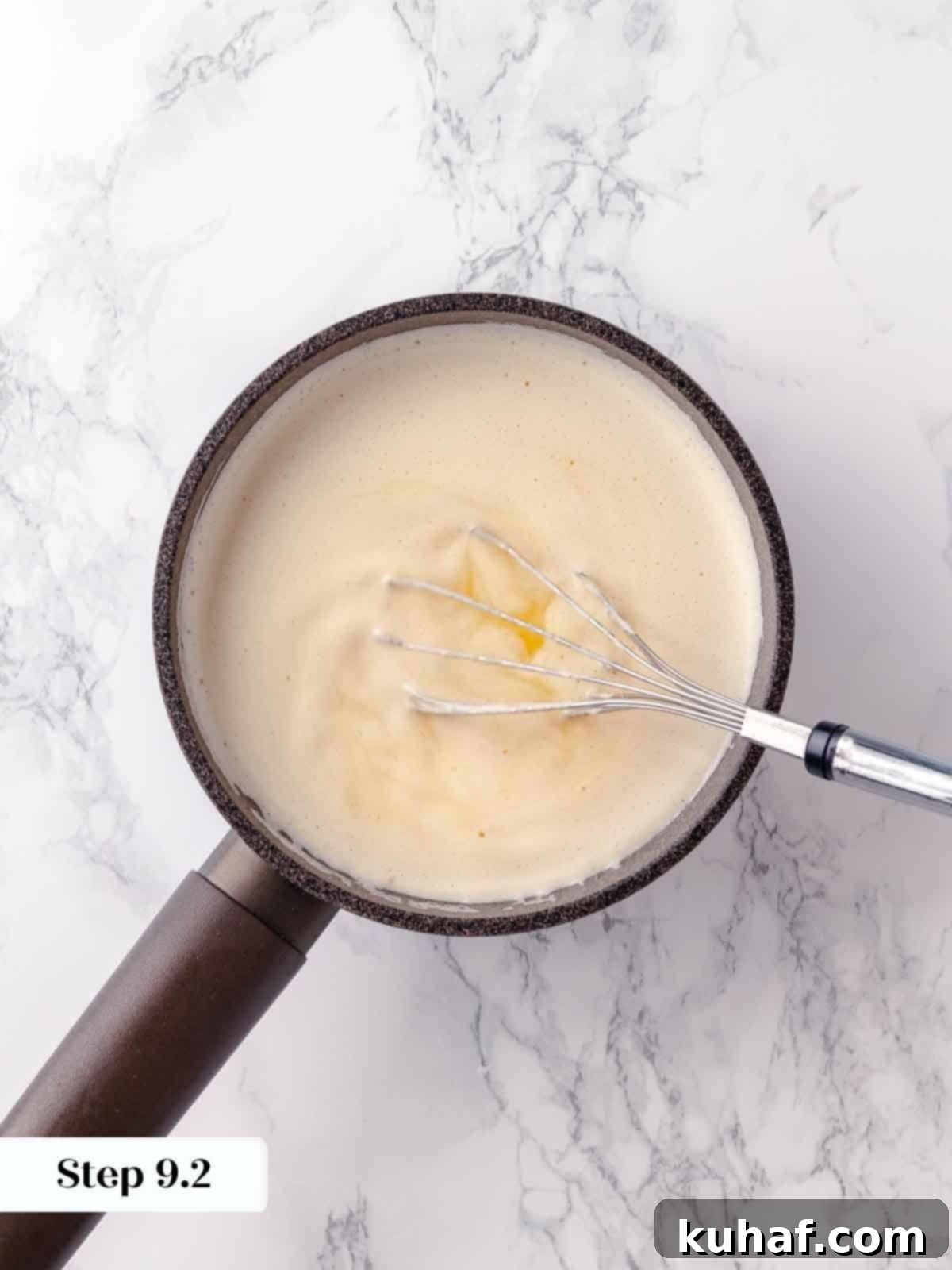 Butter being expertly whisked into a bright lemon mixture, creating a glossy, smooth pie filling with perfect consistency.