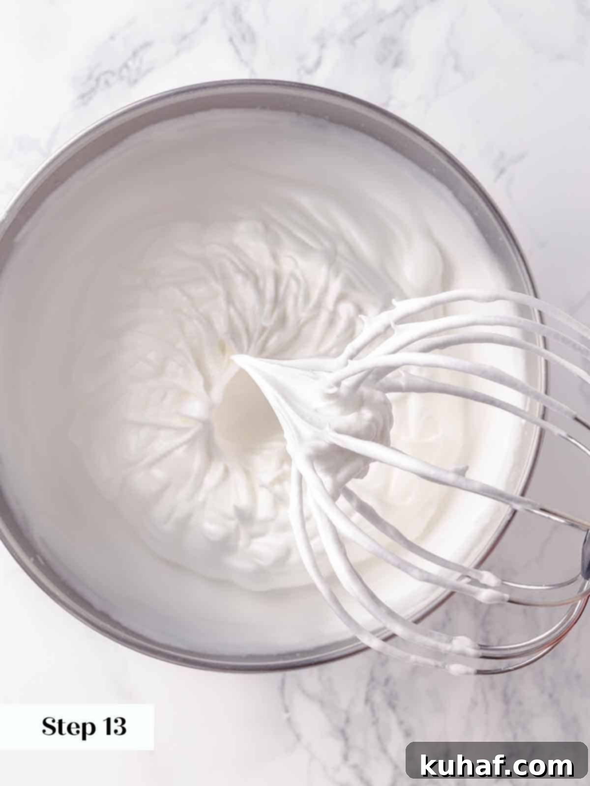 Soft, elegant peaks of whipped meringue glistening in a bowl, perfectly prepared and ready to be used as a magnificent topping for the lemon pie.