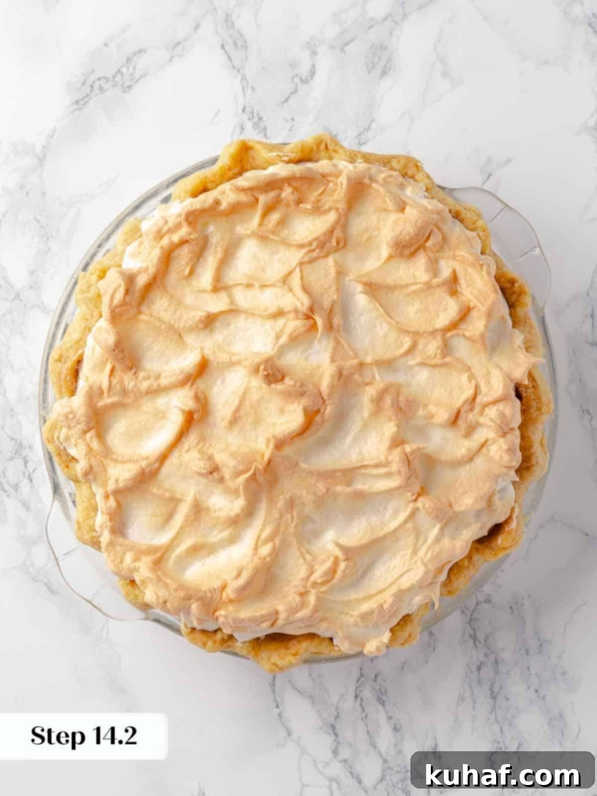 A tantalizing close-up shot of perfectly bruleed meringue atop a vibrant lemon pie, highlighting the beautifully caramelized, toasted peaks.