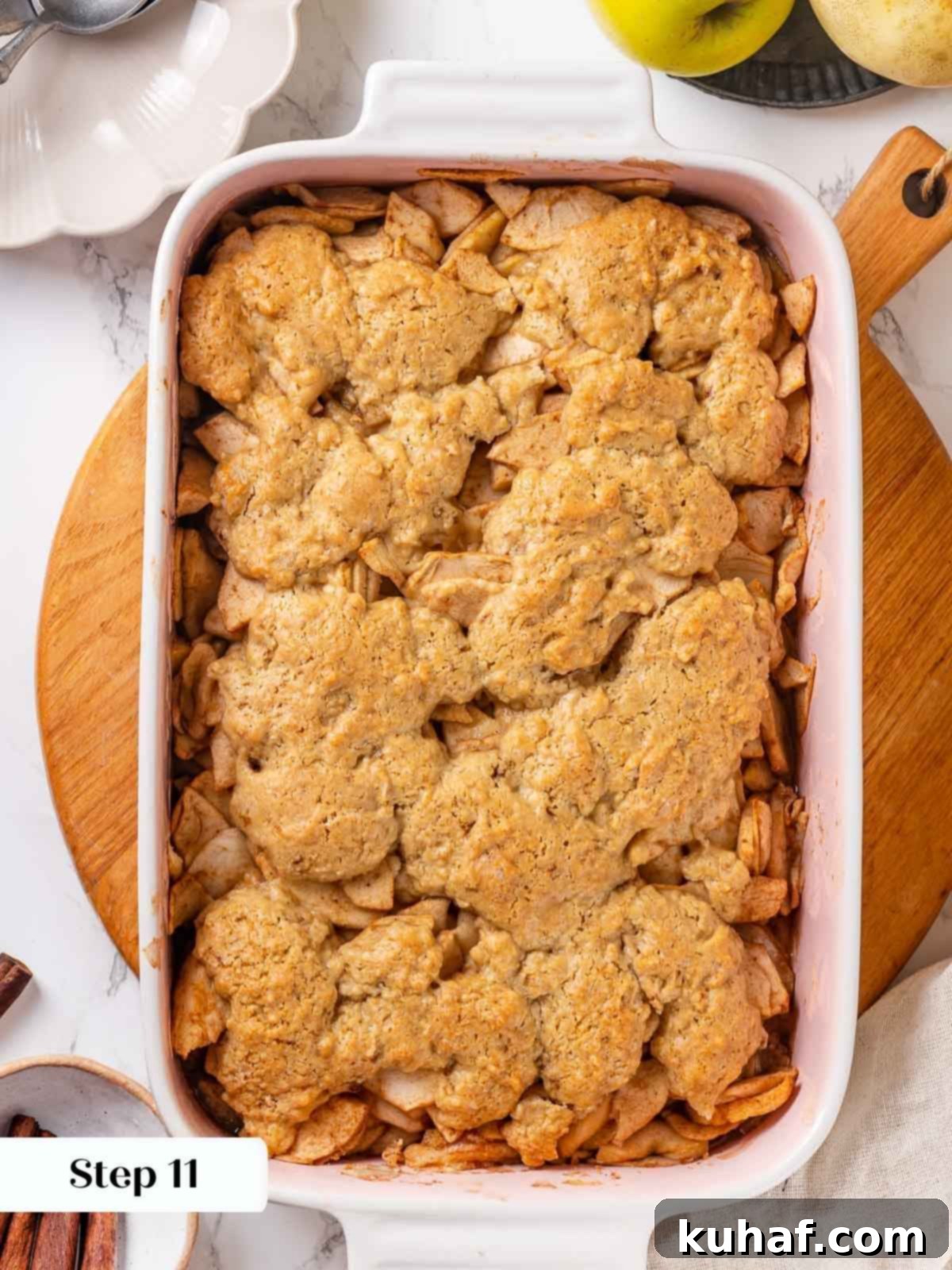 Fully baked apple cobbler, showcasing a golden brown biscuit topping and bubbly filling.