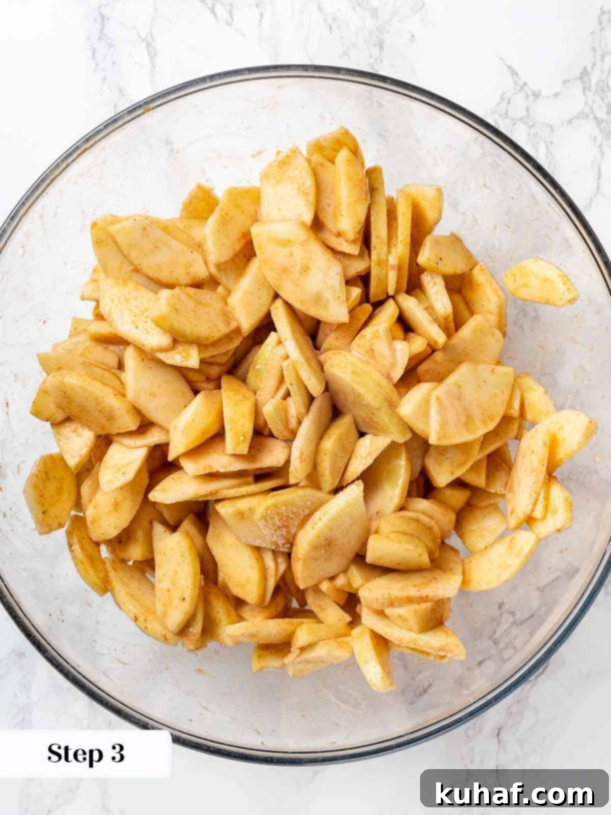 Apple slices mixed with spices and sugar, ready for the cobbler filling.