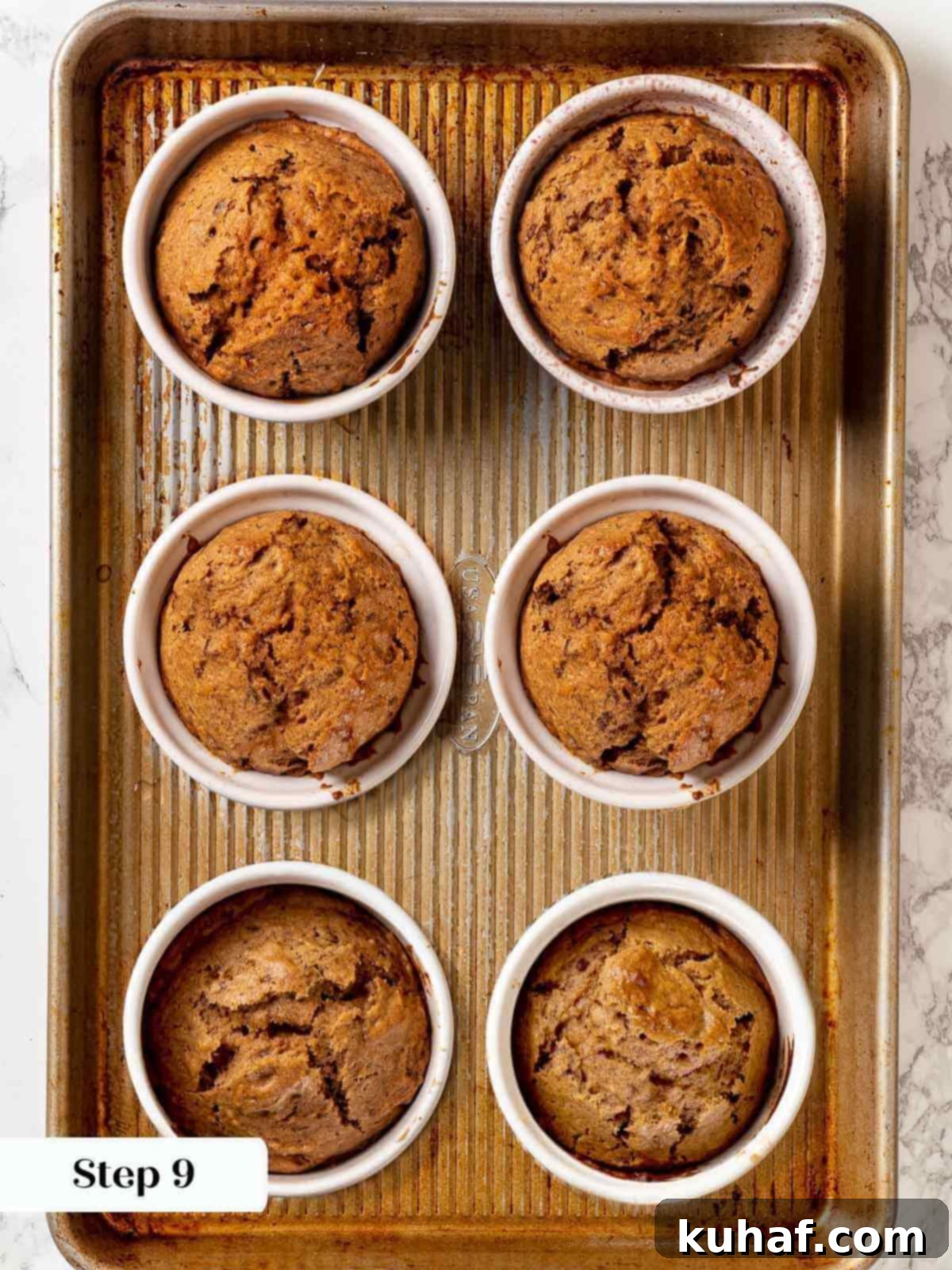 Baked sticky toffee pudding in ramekins, freshly taken out of the oven.