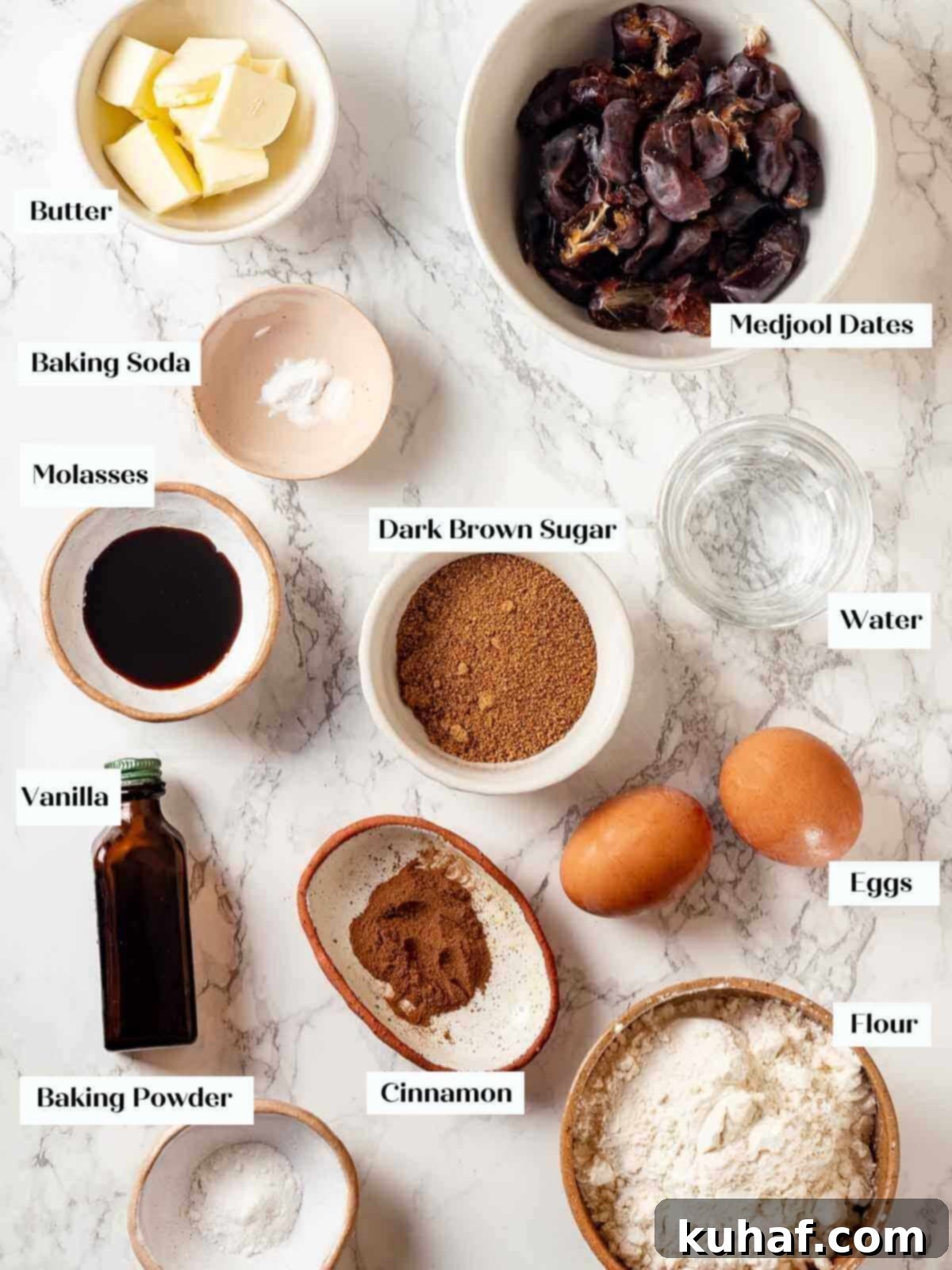 Ingredients for sticky toffee pudding arranged on a white marble surface.