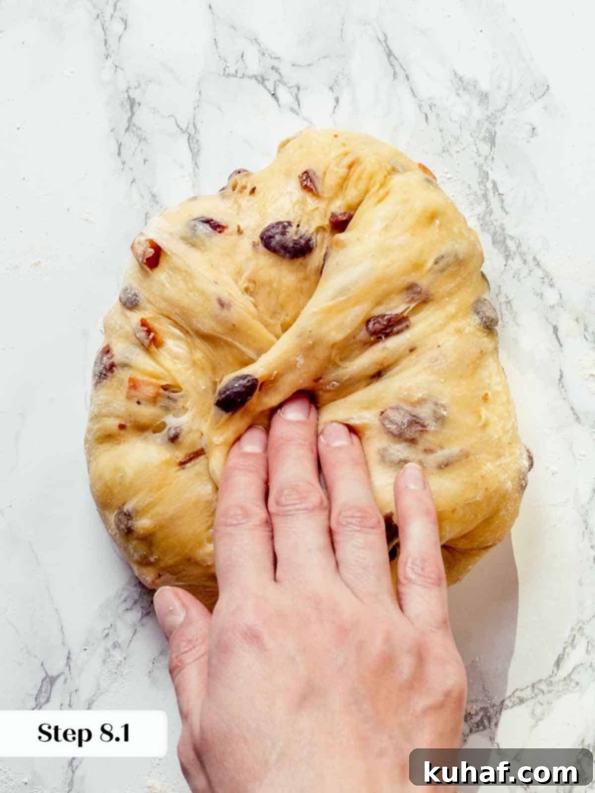 Panettone dough during the final shaping, with intricate folds creating structure and a smooth exterior.