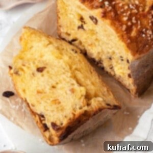 A delicious piece of panettone bread, showcasing its airy crumb and flavorful inclusions.