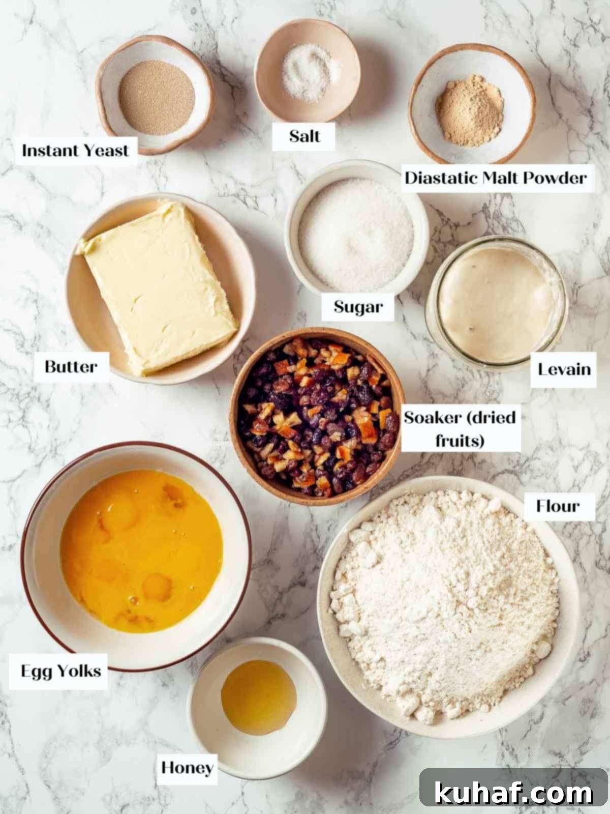 All the panettone ingredients meticulously arranged on a pristine white marble countertop, ready for baking.