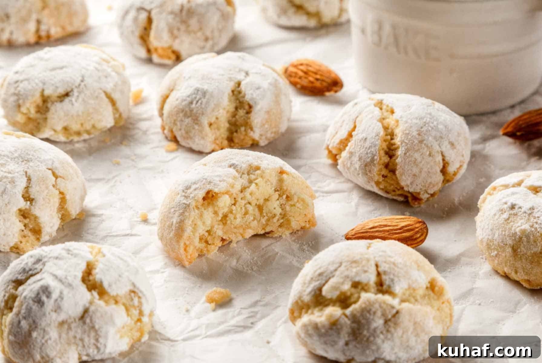 Classic Amaretti Cookies 3 A plate full of freshly baked soft amaretti cookies, lightly dusted with powdered sugar, ready to be served.