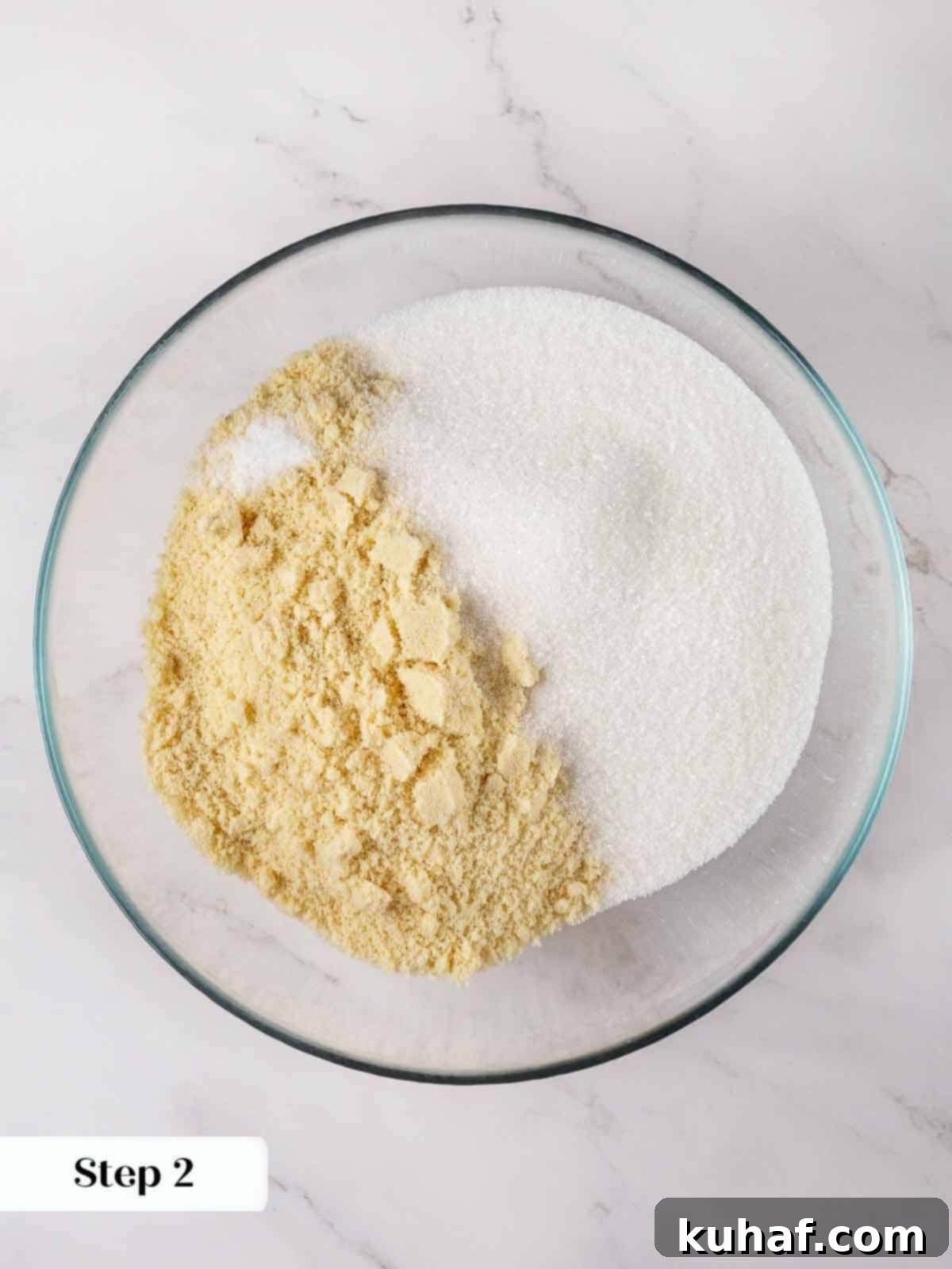 Classic Amaretti Cookies 5 Step-by-step image showing whipped egg whites in a mixing bowl.
