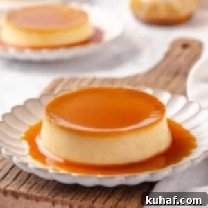 A single portion of crème caramel with a glossy amber caramel top, perfectly unmolded and served on a pristine white plate.