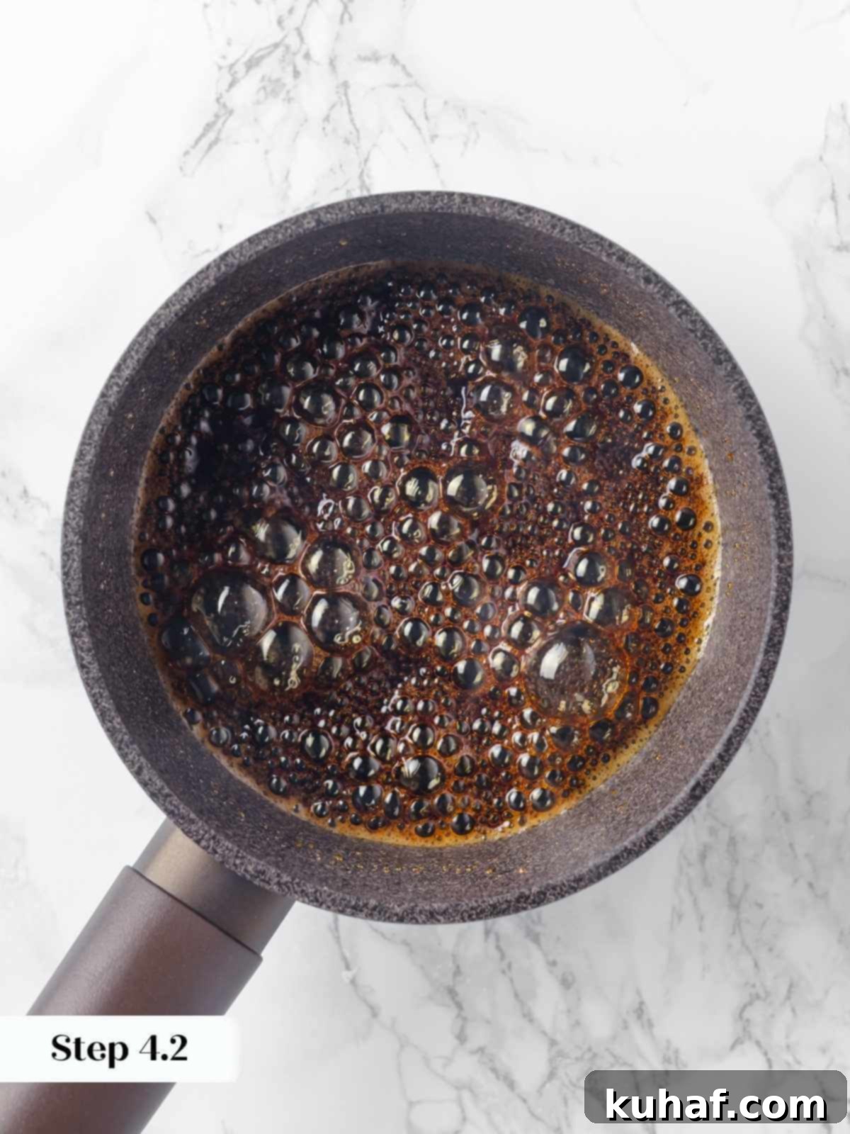 Golden caramelized sugar bubbling in a pan, at the perfect medium amber stage, ready to be poured into ramekins.