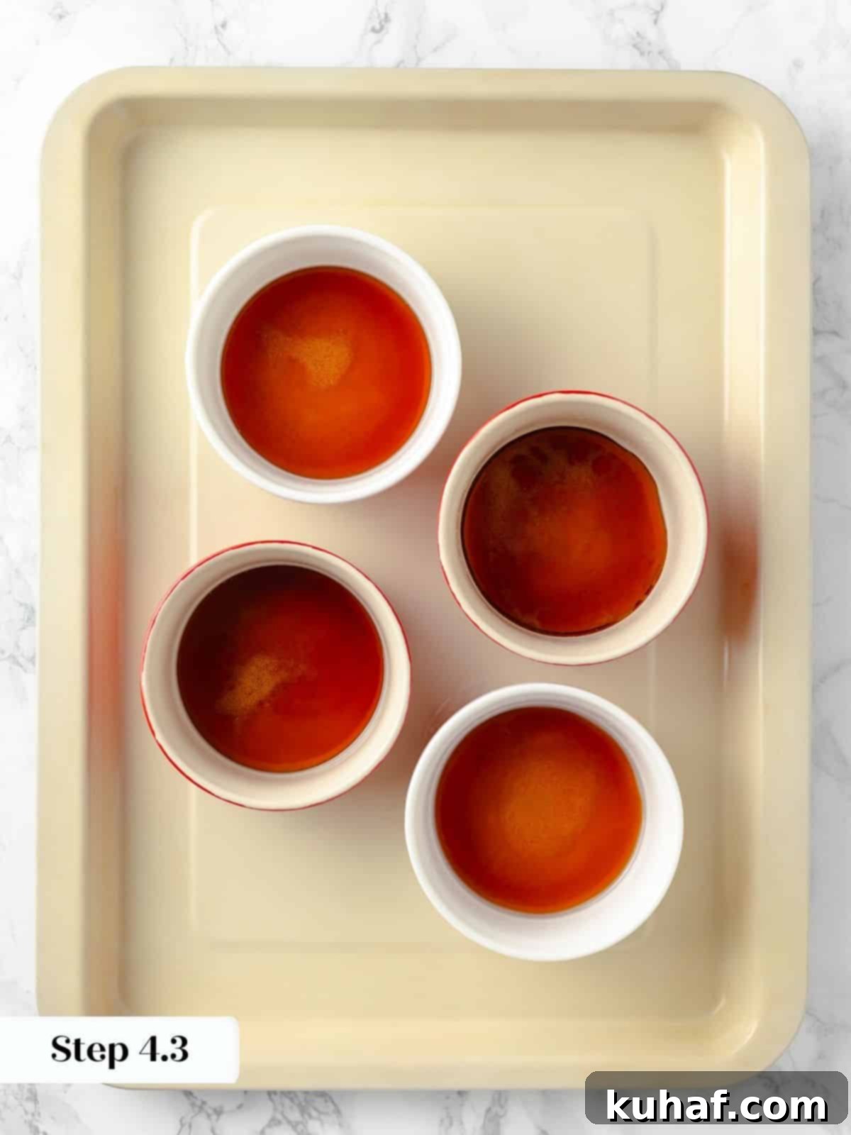 Ramekins filled with perfectly set caramelized sugar, awaiting the delicate custard mixture.