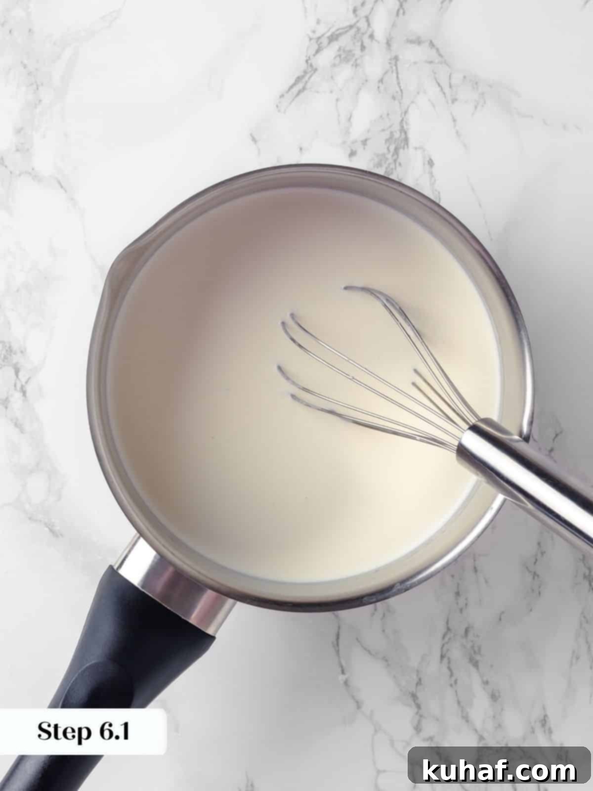 Milk and cream gently heating in a saucepan, producing subtle steam, for the rich custard base of crème caramel.