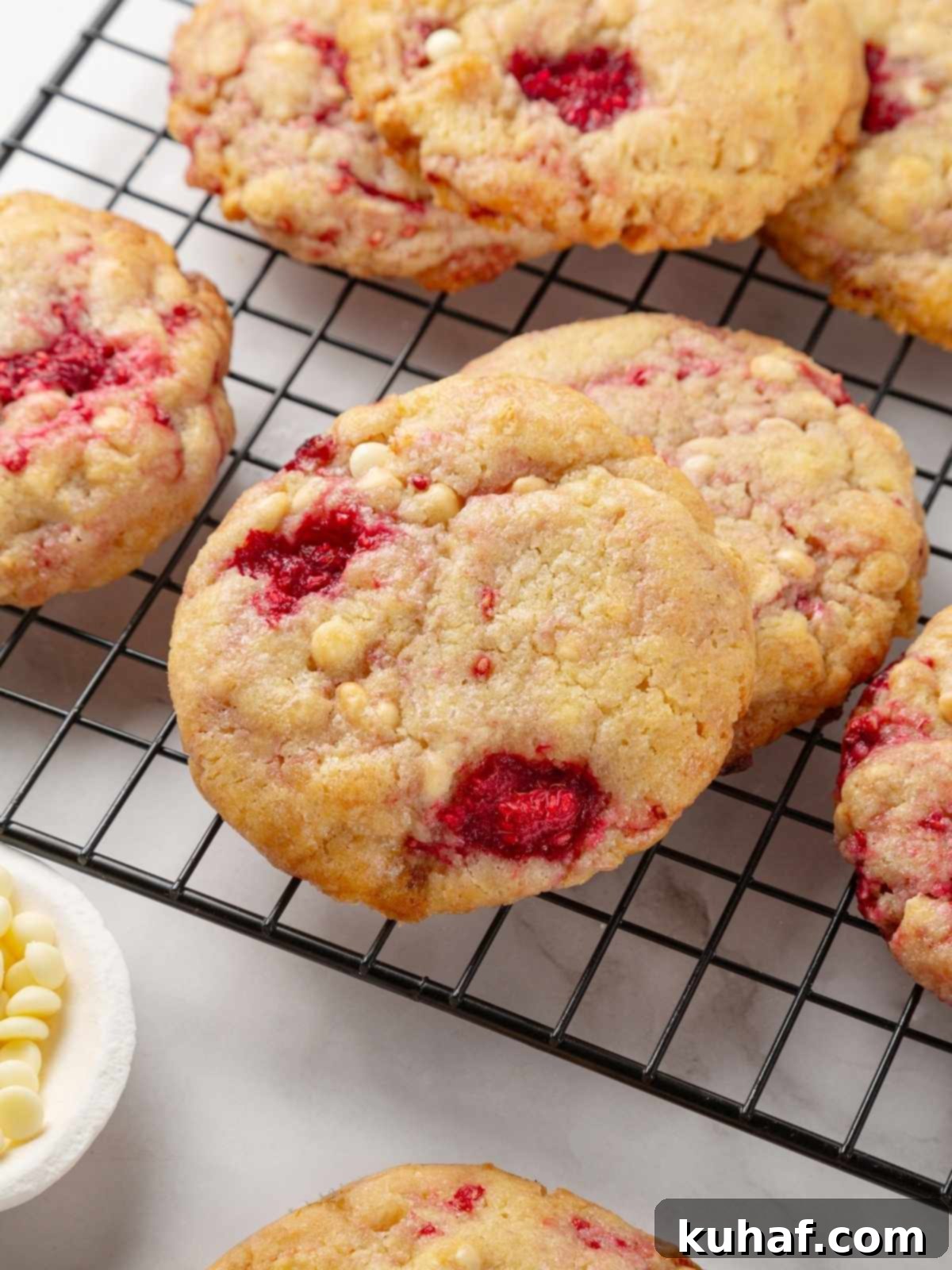 Luscious White Chocolate Raspberry Cookies 16 White chocolate raspberry cookies cooling on a wire rack, ready to be enjoyed.