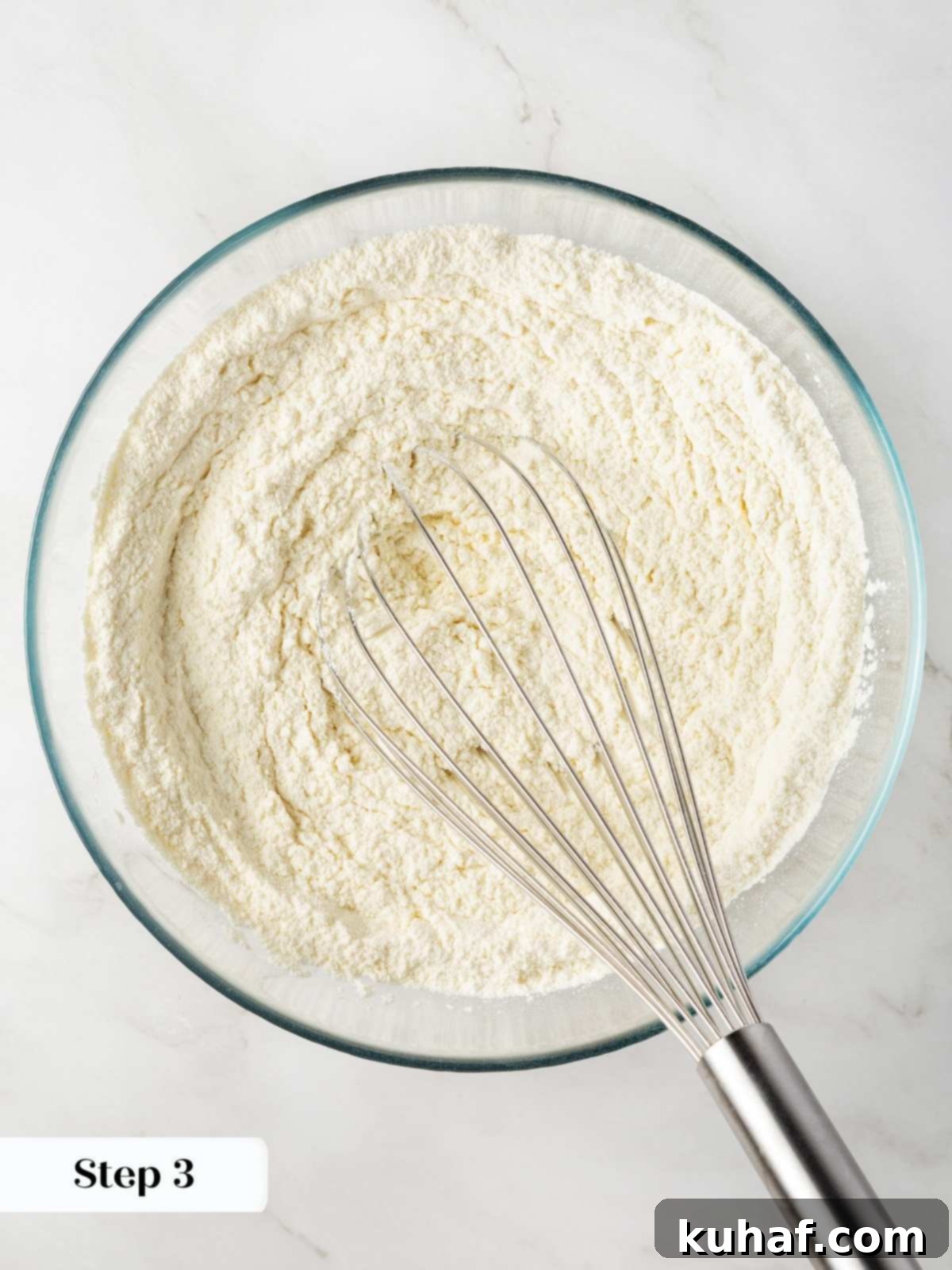 Luscious White Chocolate Raspberry Cookies 5 Dry ingredients being whisked together in a bowl to ensure even distribution for the cookie dough.