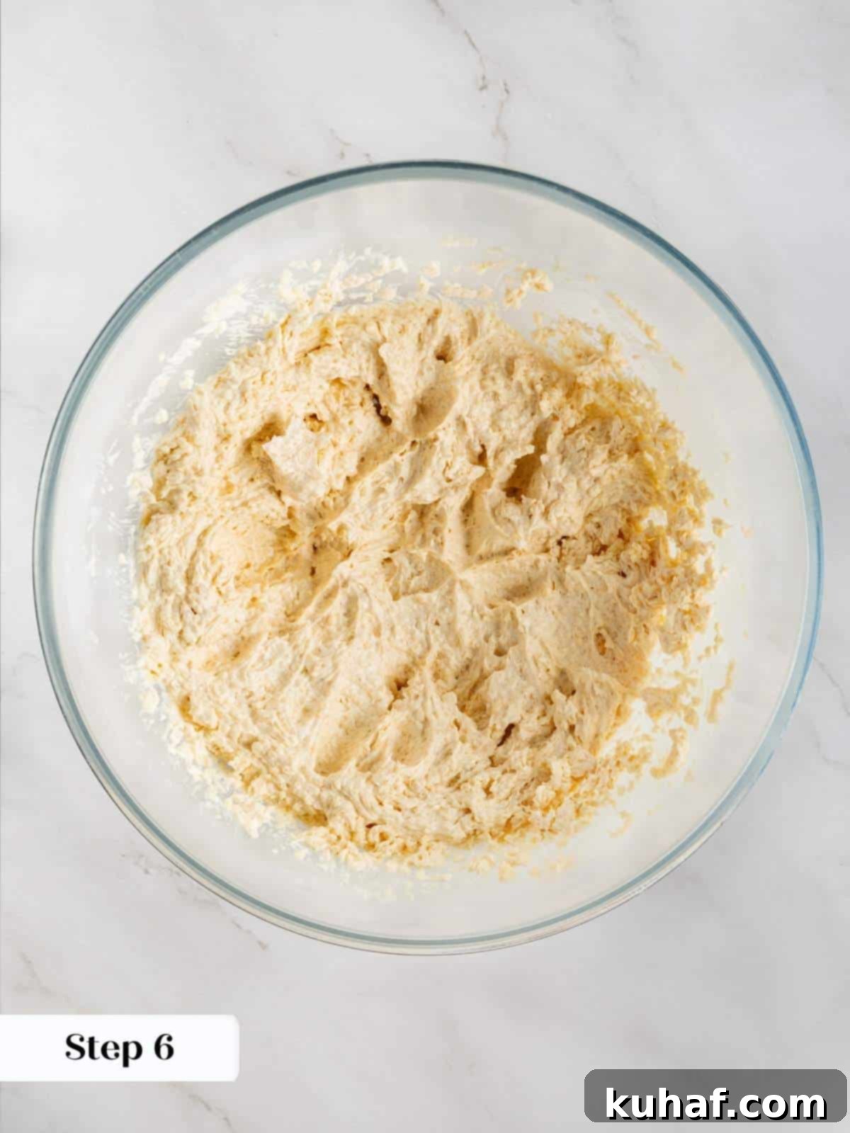 Luscious White Chocolate Raspberry Cookies 7 Cookie dough being mixed with eggs and vanilla extract for a rich, flavorful base.
