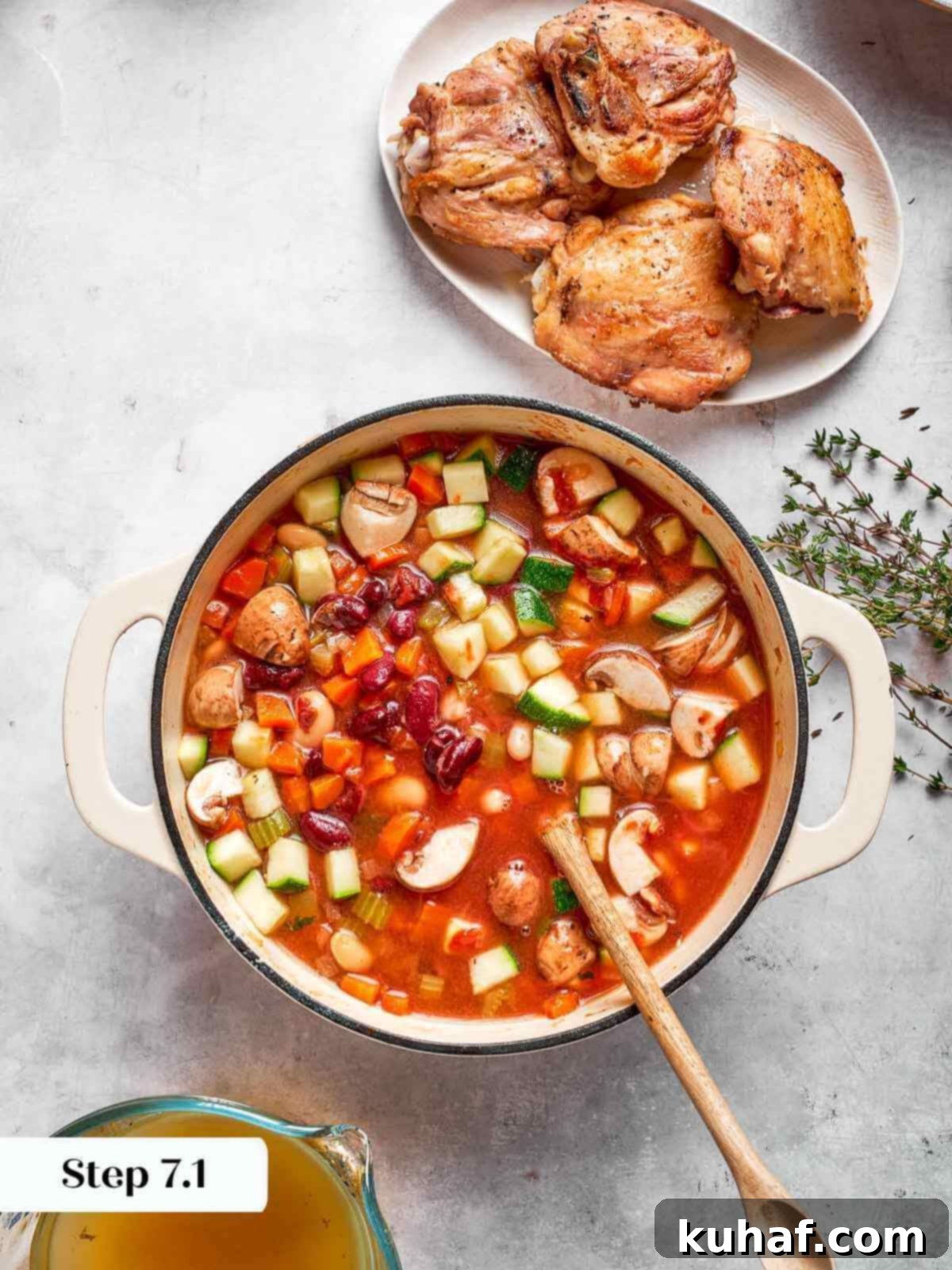 Comforting Chicken Garden Soup 12 The vegetable stock being added to the pot of simmering vegetables and chicken.