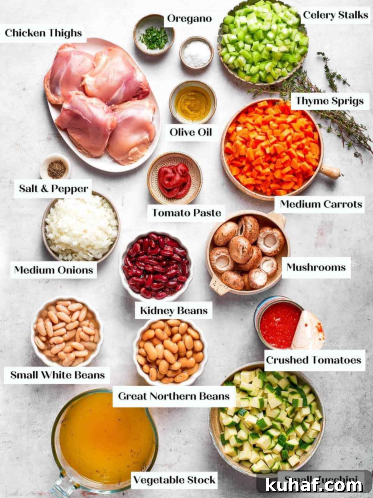 Comforting Chicken Garden Soup 4 All the fresh ingredients for chicken vegetable soup neatly arranged on a white marble countertop.