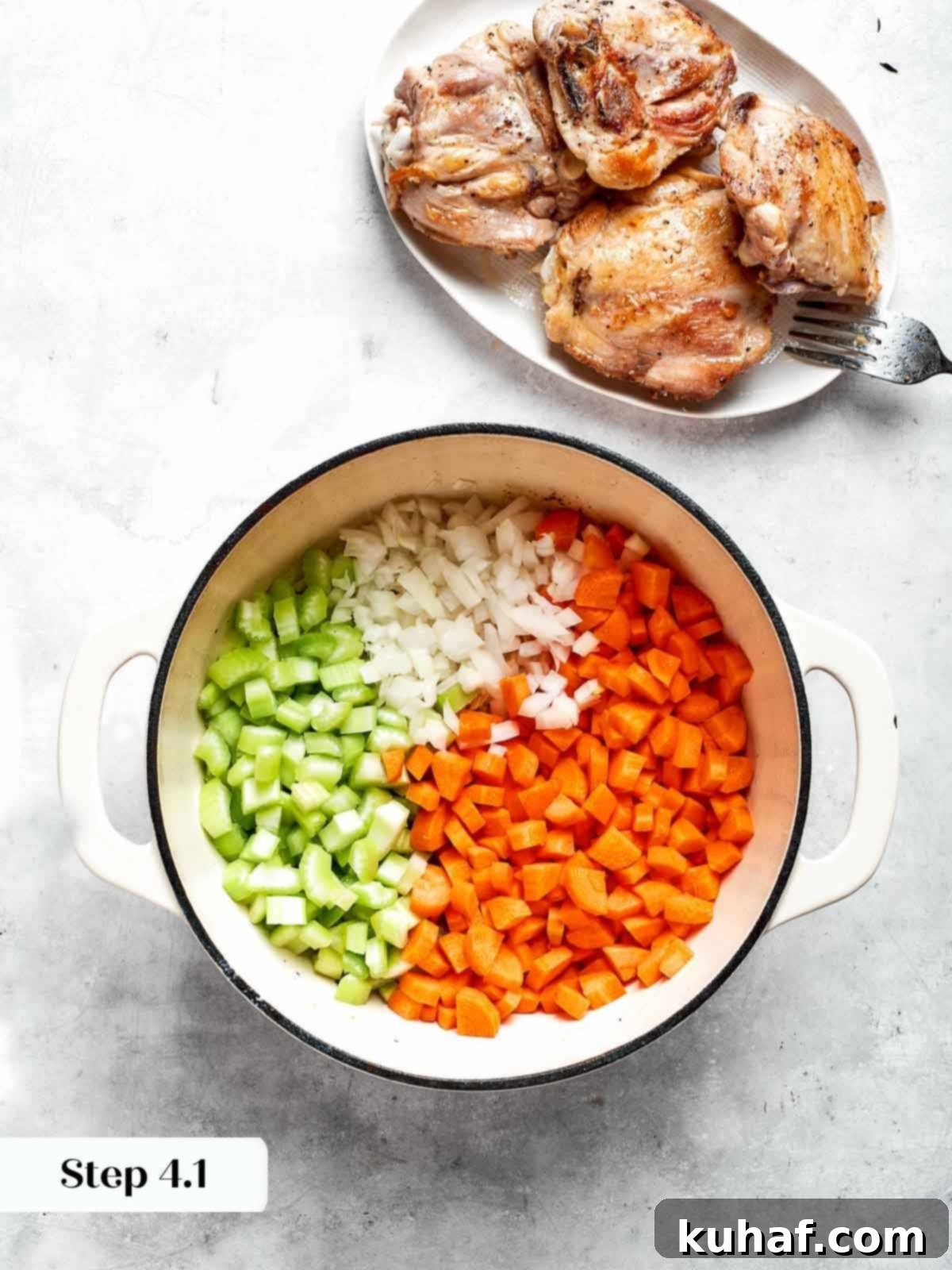 Comforting Chicken Garden Soup 7 Freshly diced carrots, onions, and celery added to the hot pot for sautéing.