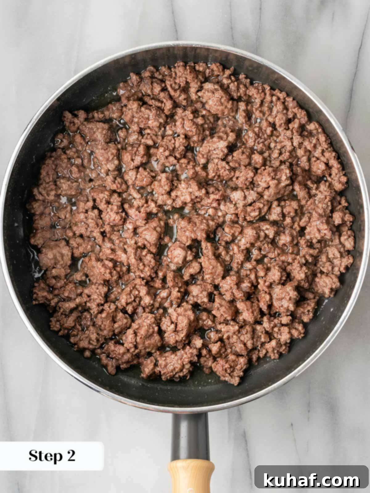 ground beef cooking in sauce pan.
