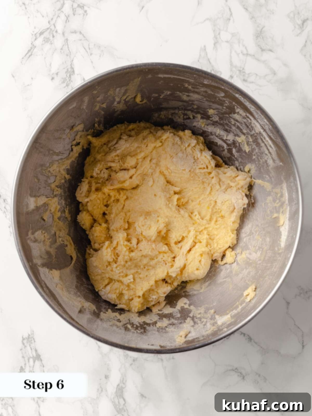 A close-up of dough forming into a soft, elastic texture.