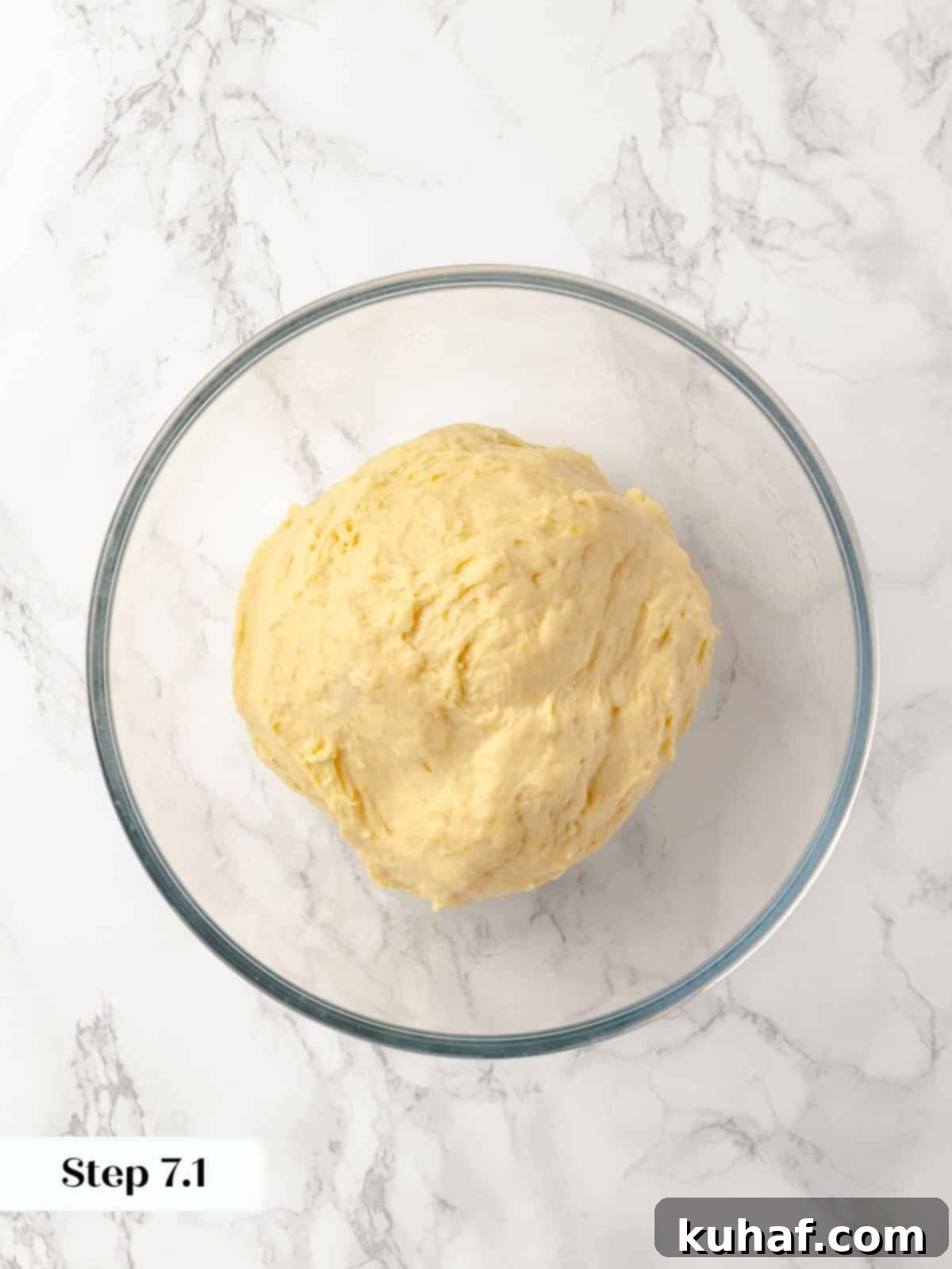 Sticky bun dough resting in a lightly oiled bowl for proofing.