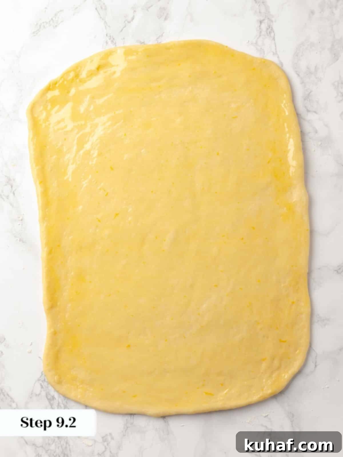 A large sheet of dough brushed with melted butter.