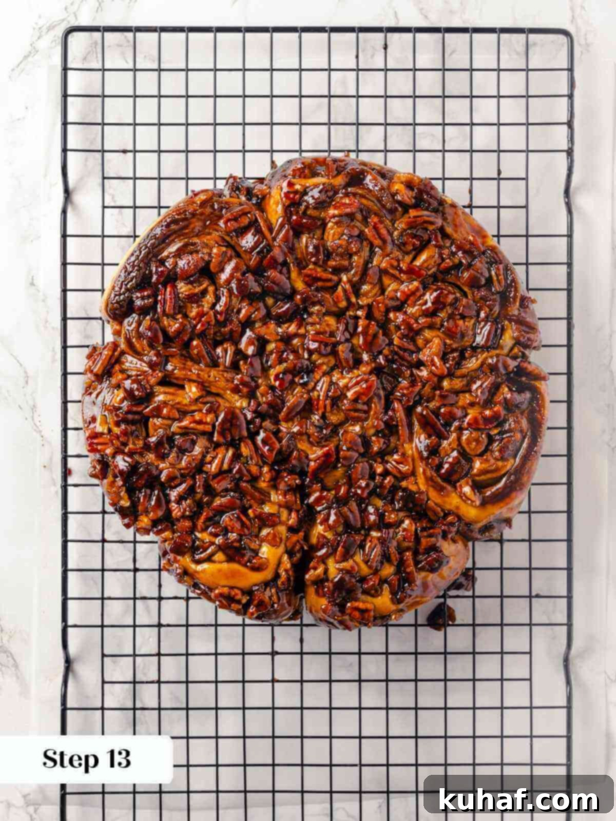 Sticky buns cooling on a wire rack after baking.