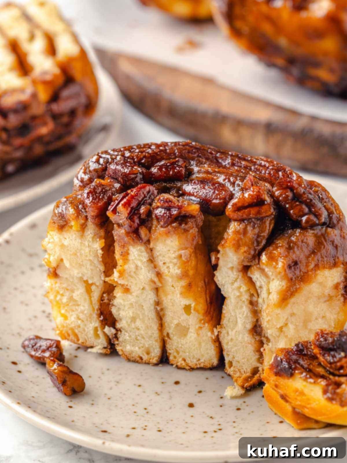 Gooey pecan sticky buns on a plate, ready to enjoy.